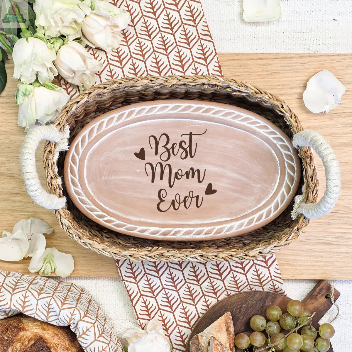The Handmade Bread Warmer & Wicker Basket - Mom Oval: Design 3 features an oval ceramic plate with "Best Mom Ever," nestled in a wicker basket—ideal for Mother’s Day or any occasion for bread lovers.