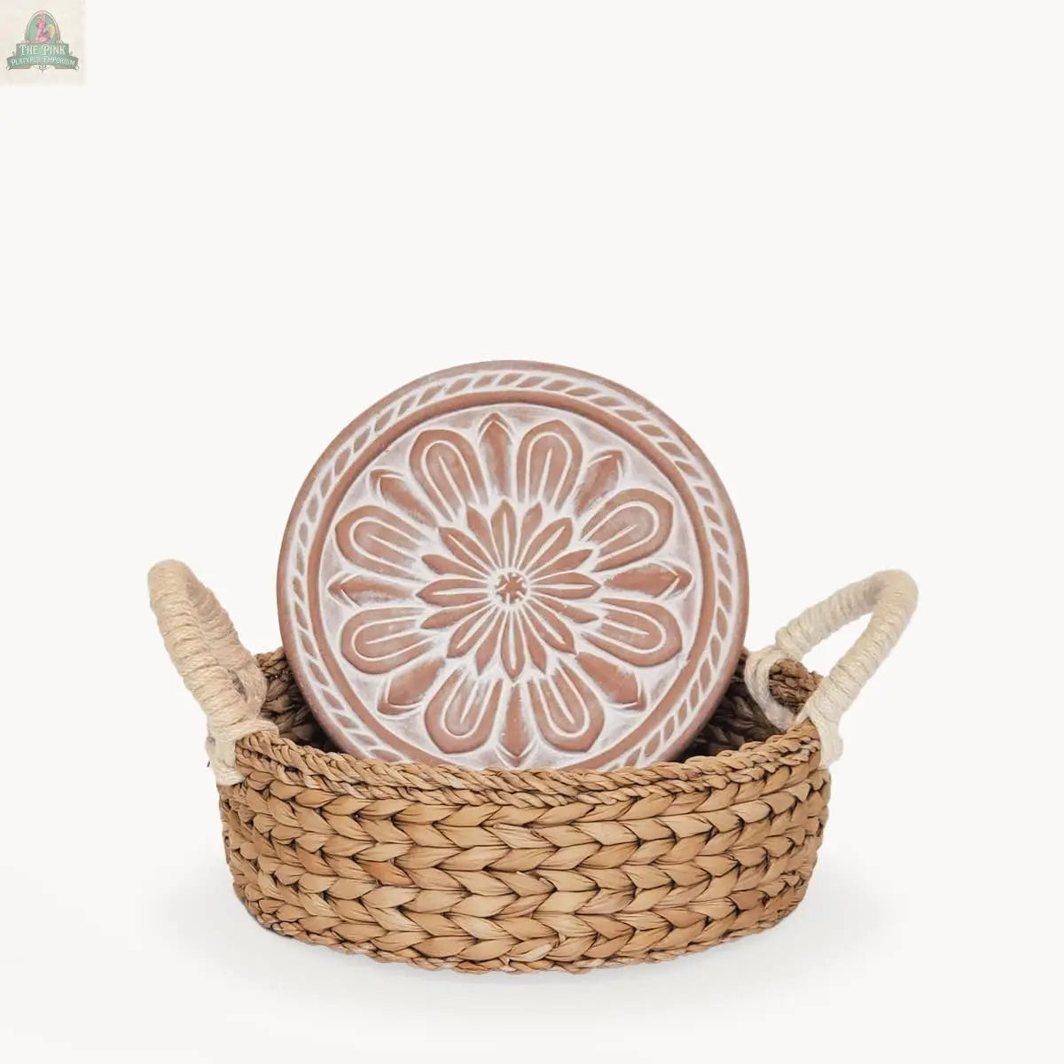 The KORISSA Handmade Bread Warmer & Wicker Basket - Vintage Flower features a round ceramic plate with a white floral design, a terracotta warming stone, and basket with two handles, all displayed on a plain white background.