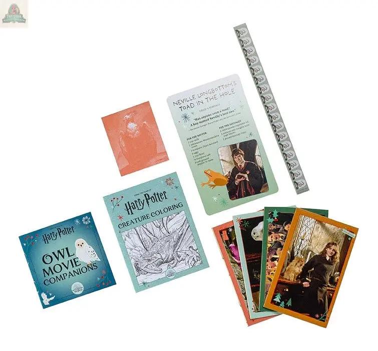 Discover the Harry Potter Holiday Magic: Official Advent Calendar—packed with Wizarding World collectibles like character cards, a bookmark, a toad recipe card, a coloring book, an owl activity book, and a translucent red card for festive fun.