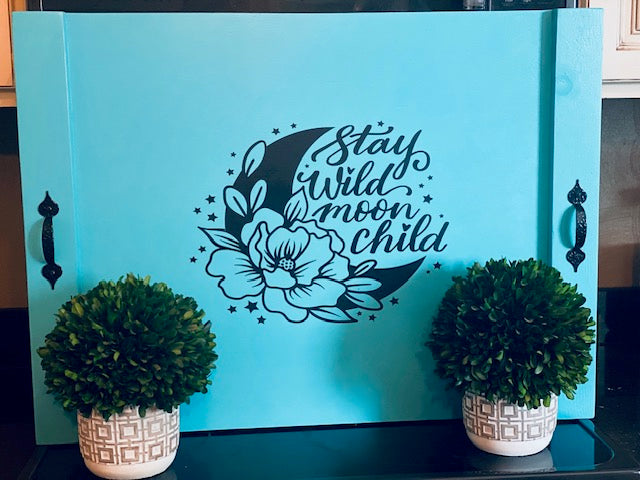 Unique boho gift for women featuring a Stay Wild Moon Child wooden stove cover with celestial moon and floral design.