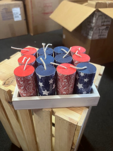 Decorative fireworks with American flag design on a wooden stand.