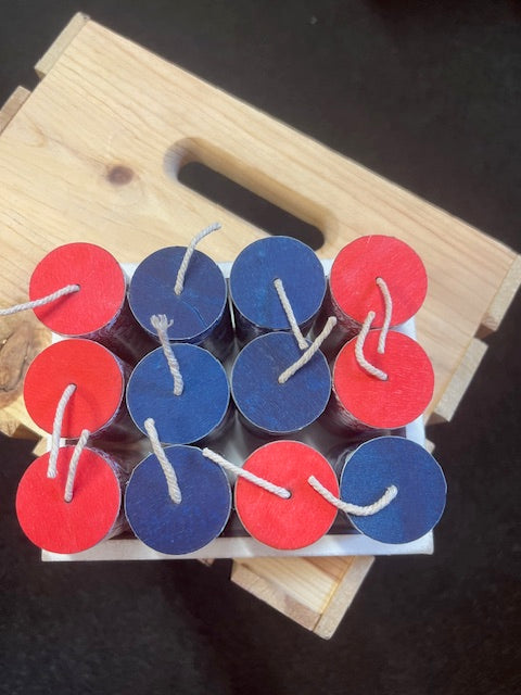 Red and blue decorative fireworks on a wooden stand with a dark background
