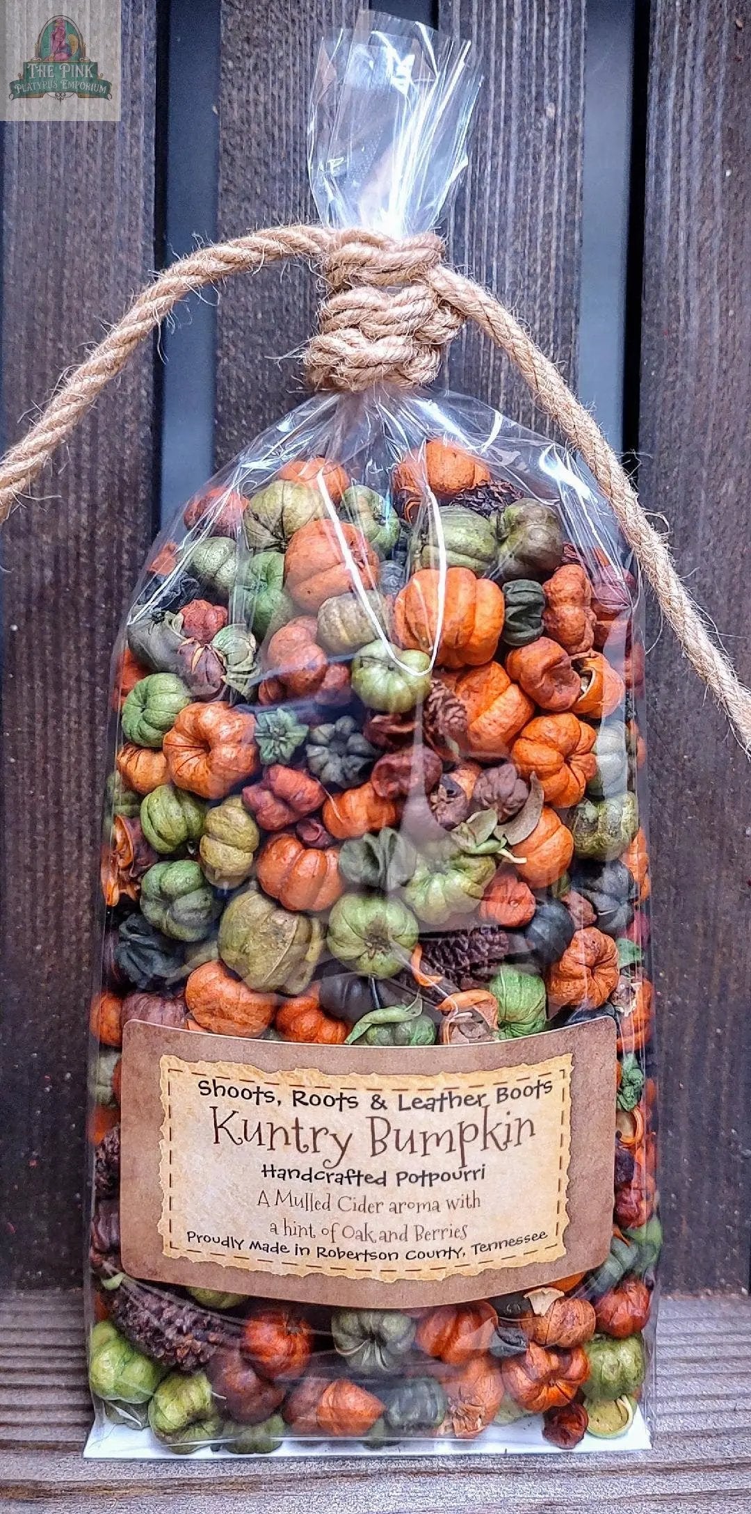 A clear bag of colorful, mini pumpkin-shaped potpourri in orange, green, and brown, tied with twine. “Kuntry Bumpkin Handcrafted Potpourri- 5 cups” features a mulled cider scent, handcrafted in Tennessee for home fragrance.