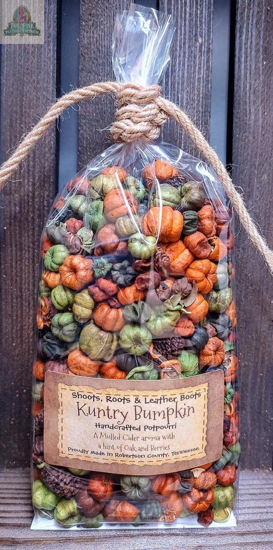 A clear bag of colorful, mini pumpkin-shaped potpourri in orange, green, and brown, tied with twine. “Kuntry Bumpkin Handcrafted Potpourri- 5 cups” features a mulled cider scent, handcrafted in Tennessee for home fragrance.