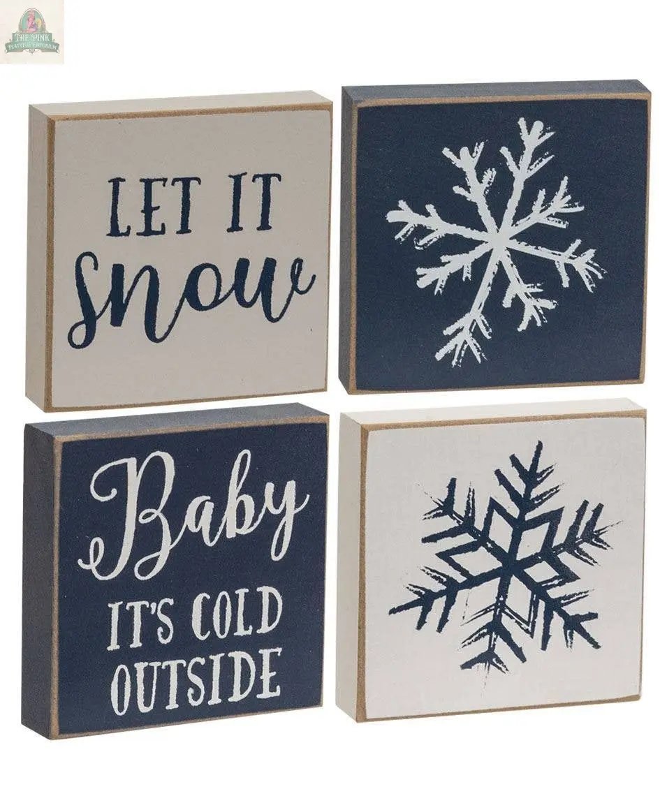 The Let It Snow/Snowflake Square Block set includes four assorted decorative wooden blocks—two with snowflakes, one with "Let It Snow," and one with "Baby IT'S COLD OUTSIDE"—perfect for charming farmhouse winter decor.