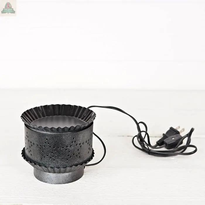 The Electric Tart Warmer-Pewter features a black, perforated metal body with a pewter finish and power cord, shown on a white surface against a plain background.