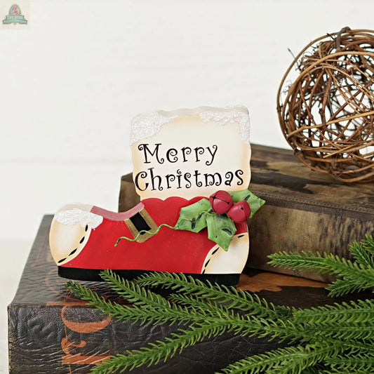 The Impressive Enterprises, Inc. Wood Red/White Snow Boot sign (5" x 4.25") adds festive charm to your décor with its bright red boot shape and "Merry Christmas" text—perfect for holiday displays or tabletops.