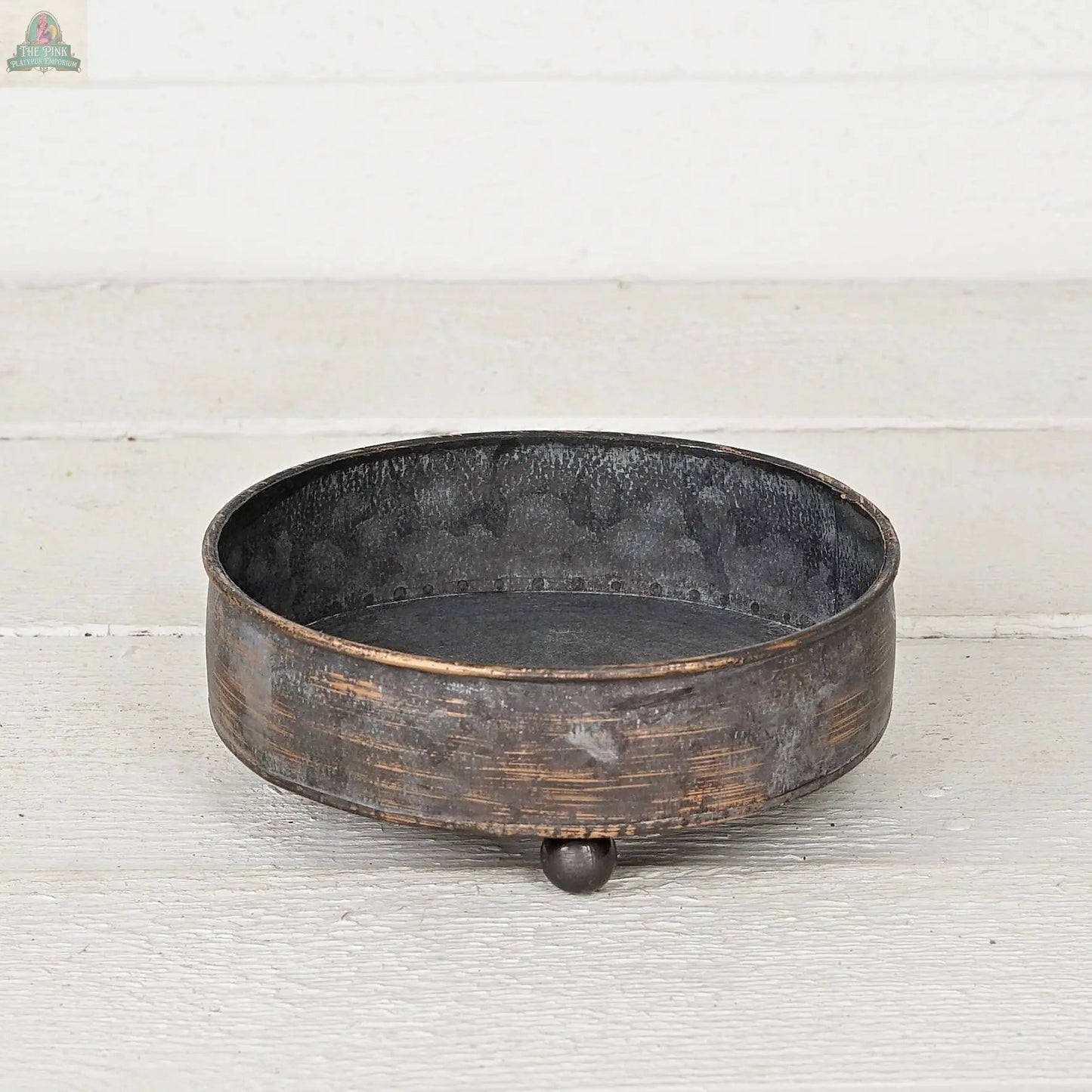 The Antique Pewter metal round Bowl container (6.5inD) by Impressive Enterprises, Inc. features a rustic, weathered finish and three ball feet—ideal as a decorative centerpiece for your table decor.