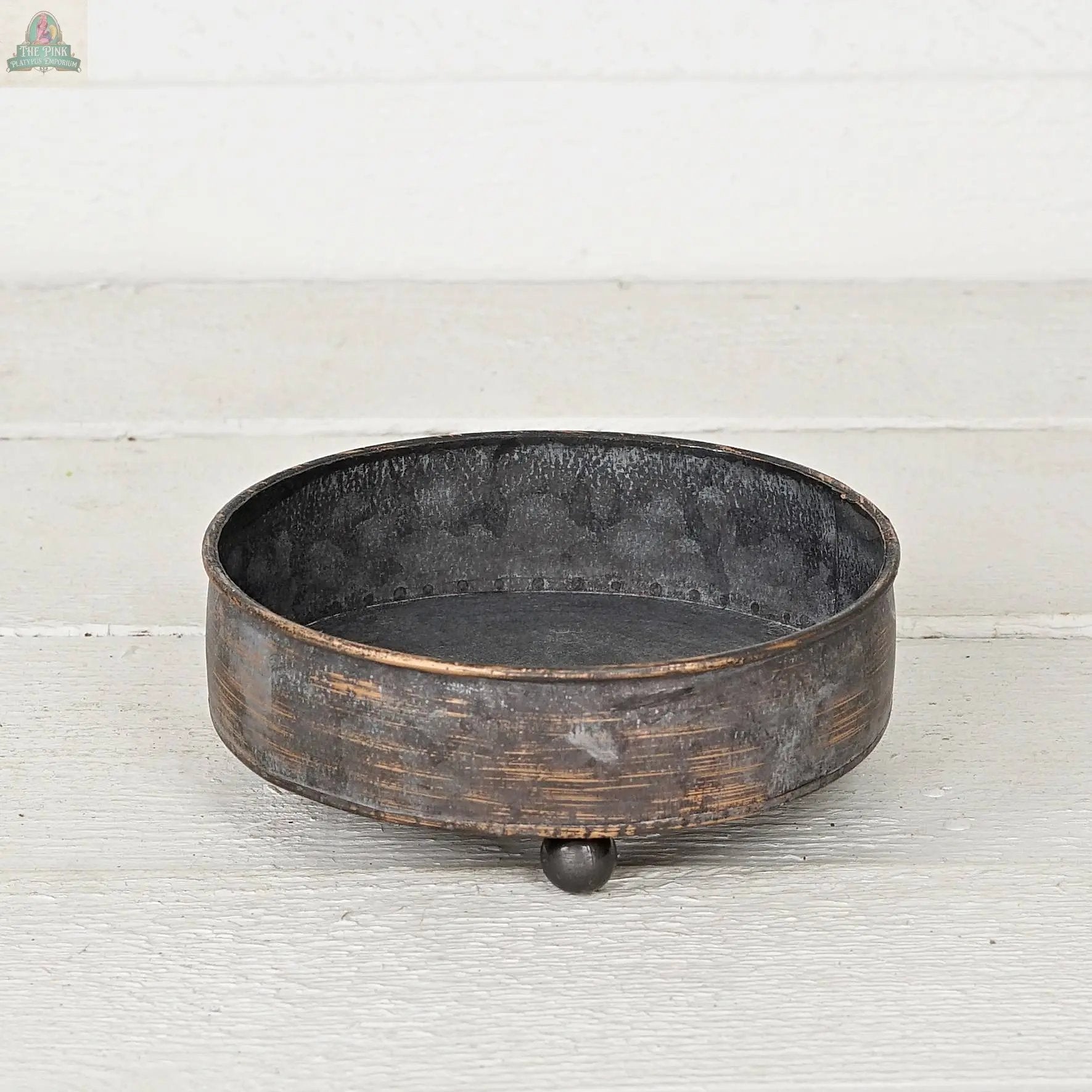 The Antique Pewter metal round Bowl container (6.5inD) by Impressive Enterprises, Inc. features a rustic, weathered finish and three ball feet—ideal as a decorative centerpiece for your table decor.