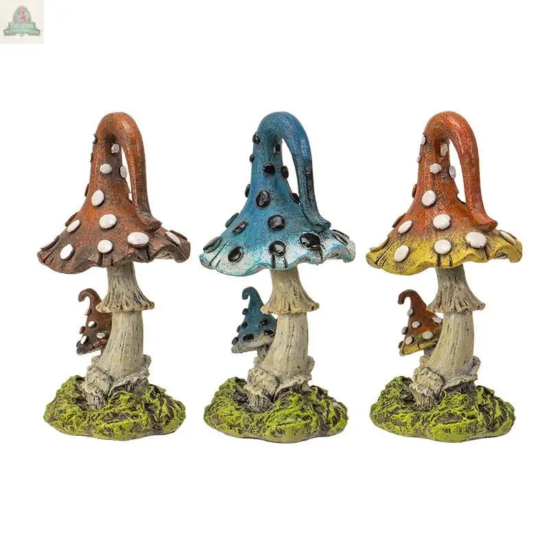 The Magic Mushroom Toadstools Home and Garden Decor Set of 3 includes red, blue, and orange statues with white spots and small mushrooms on mossy bases—delightful accents for any garden or home space.