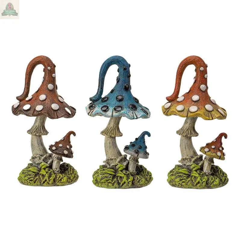 Add a touch of magic to your space with the Magic Mushroom Toadstools Home and Garden Decor Set of 3—whimsical brown, blue, and orange statues with white spots and green bases featuring mushrooms and foliage.