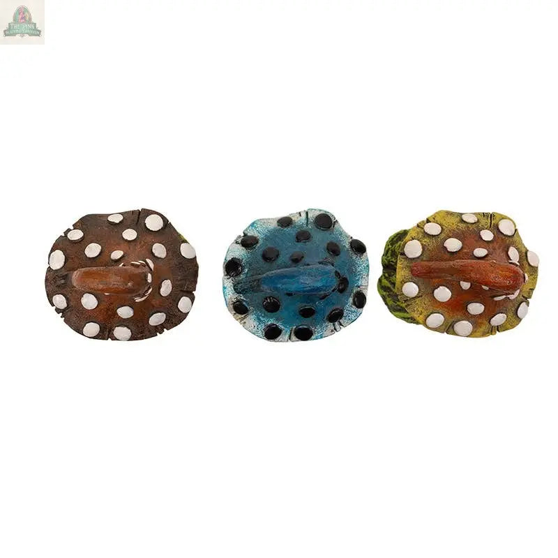 The Magic Mushroom Toadstools Home and Garden Decor Set of 3 features small, round frog-shaped figurines—brown, blue, and yellow-green—with white spots and unique mouths, adding whimsical charm to any space.