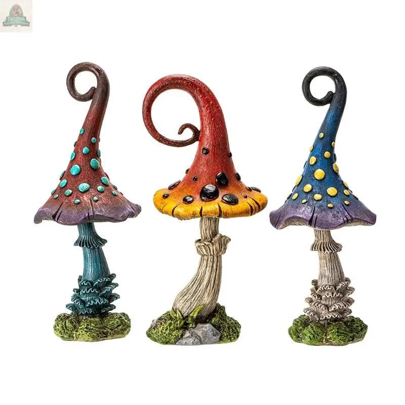 Add cottagecore charm to your space with the Magic Toadstool Mushrooms Home and Garden Decor—three whimsical statues in teal, red-orange, and blue-purple, each with twisted stems, spotted caps, and mossy bases.