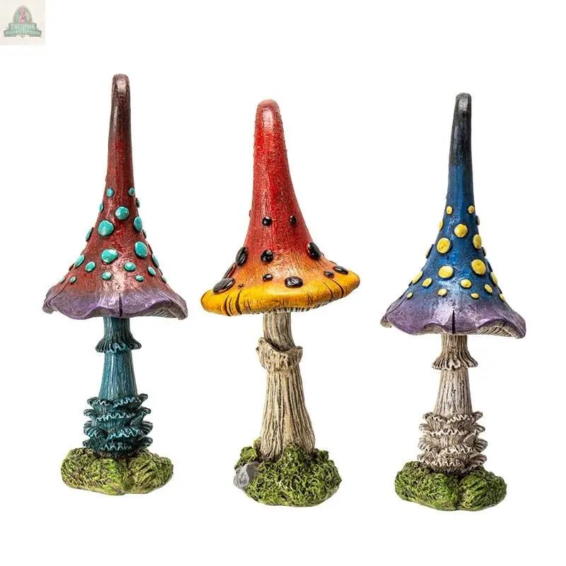Add a touch of whimsy with Magic Toadstool Mushrooms Home and Garden Decor—three colorful statues with textured stems, vibrant red, blue, and purple caps, raised spots, and charming details on green bases. Perfect for cottagecore style.