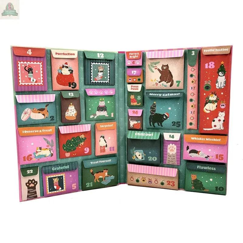 The Merry Catmas! Cat Lover's Advent features colorful, numbered compartments with winter-themed cat illustrations, festive decor, and playful captions—a purrfect holiday gift for any cat lover.