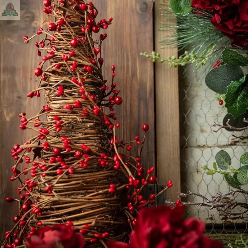 The 21" mixed berry cone tree with rust stars and a 6.25" base makes a festive centerpiece with its woven twig design, red berries, and rustic charm, ideal for holiday decor with pine and red accents.