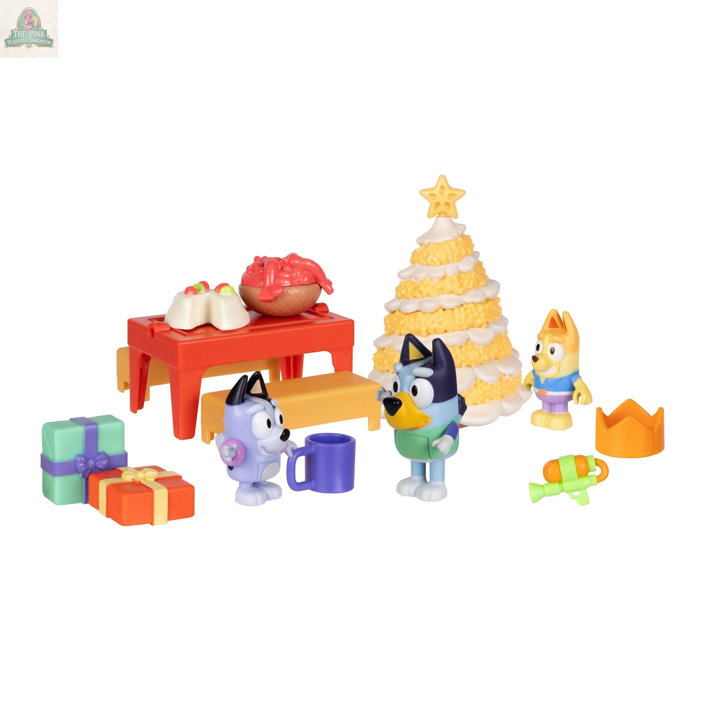 The Bluey Advent Calendar features character toys gathered at a festive table with food, a Christmas tree-shaped cake, colorful presents, and party accessories for a joyful holiday celebration.
