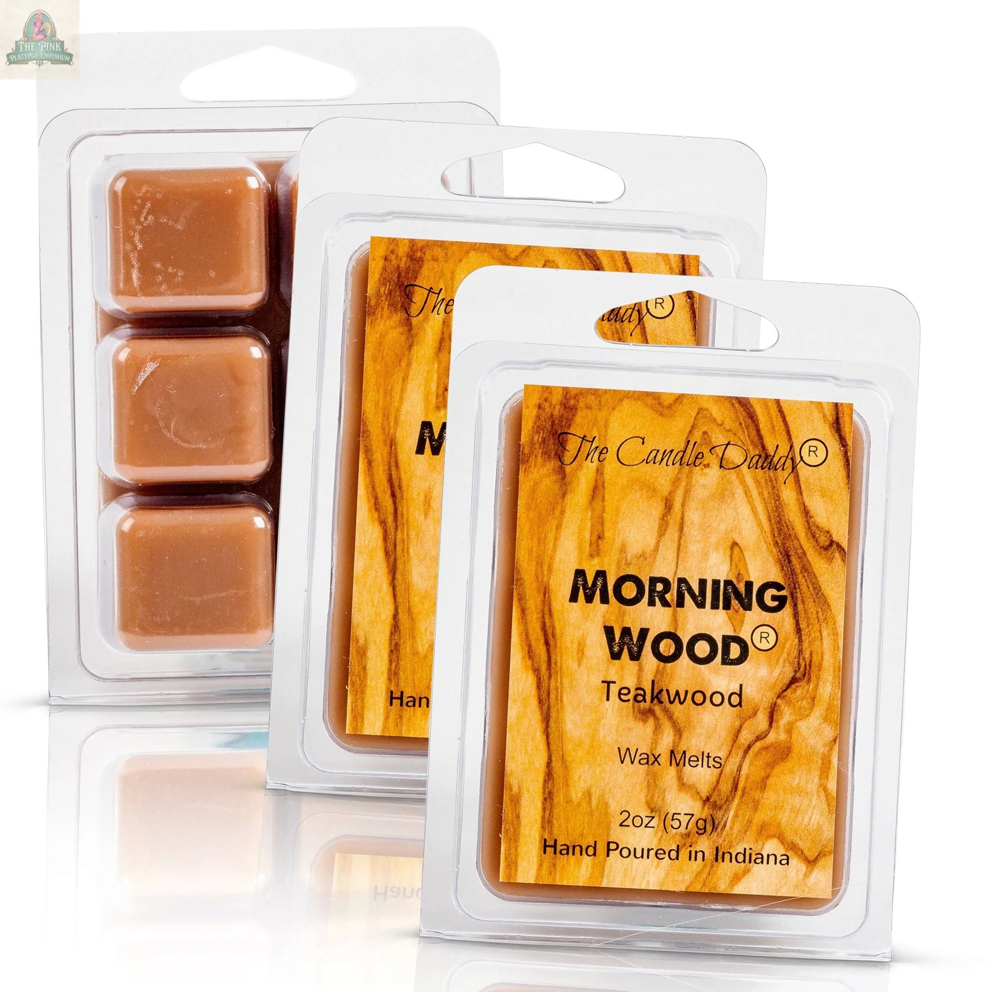 Three clamshell packs of Candle Daddy Morning Wood - Teak Wood Scented Wax Melt, each with a wood grain design and six brown cubes that deliver a strong teak wood fragrance.