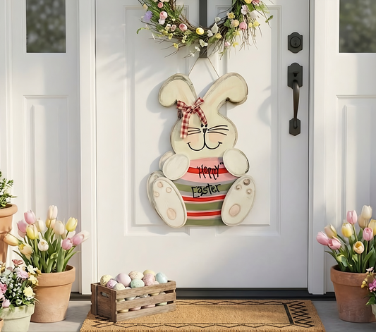 Decorative Easter bunny sign on a door with flowers and a basket below.