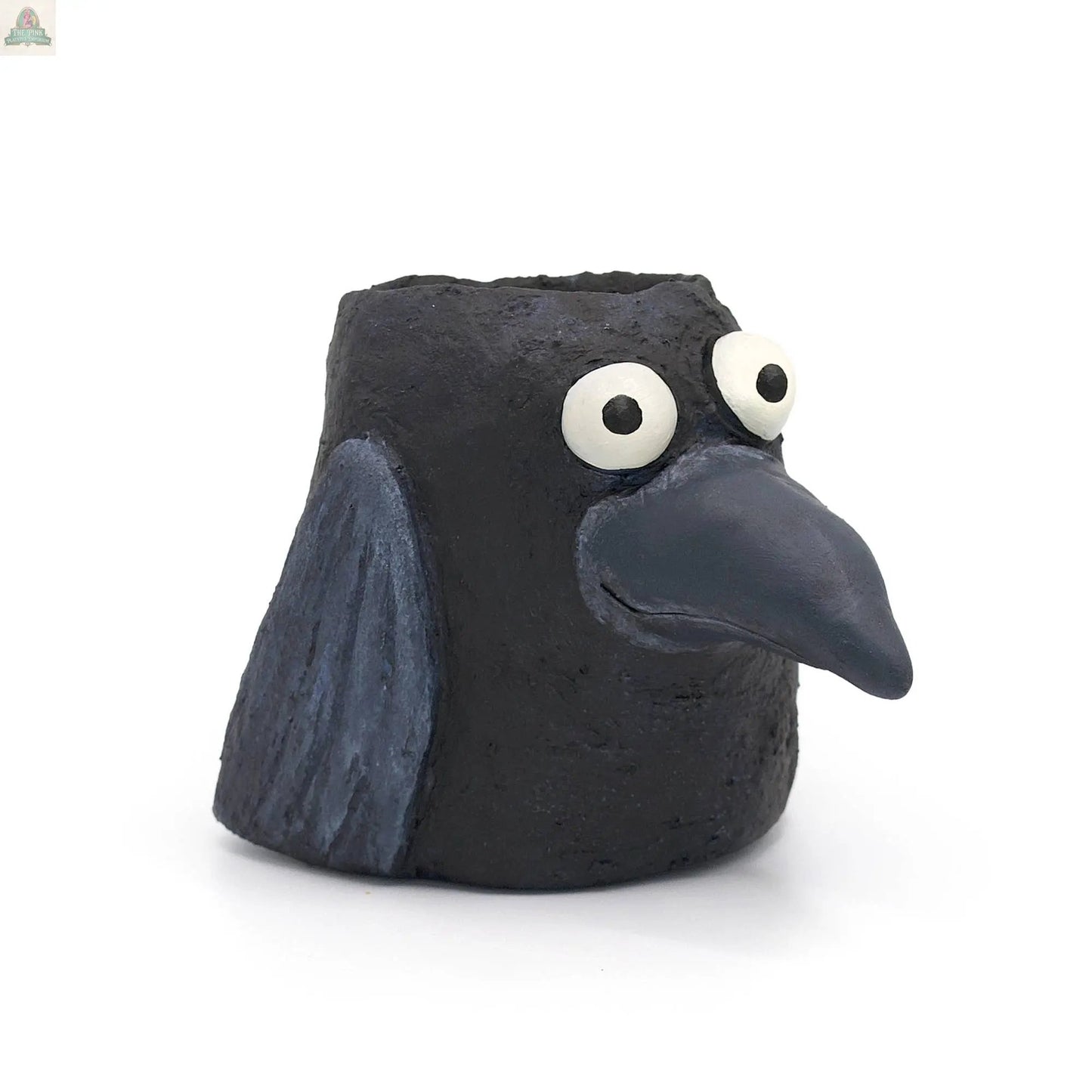 Poe the Crow Blobhouse Planter is a small, handmade poly-resin sculpture with a large beak, wide white eyes, and textured wings. This charming black bird doubles as a planter—perfect for adding unique style to your home décor.