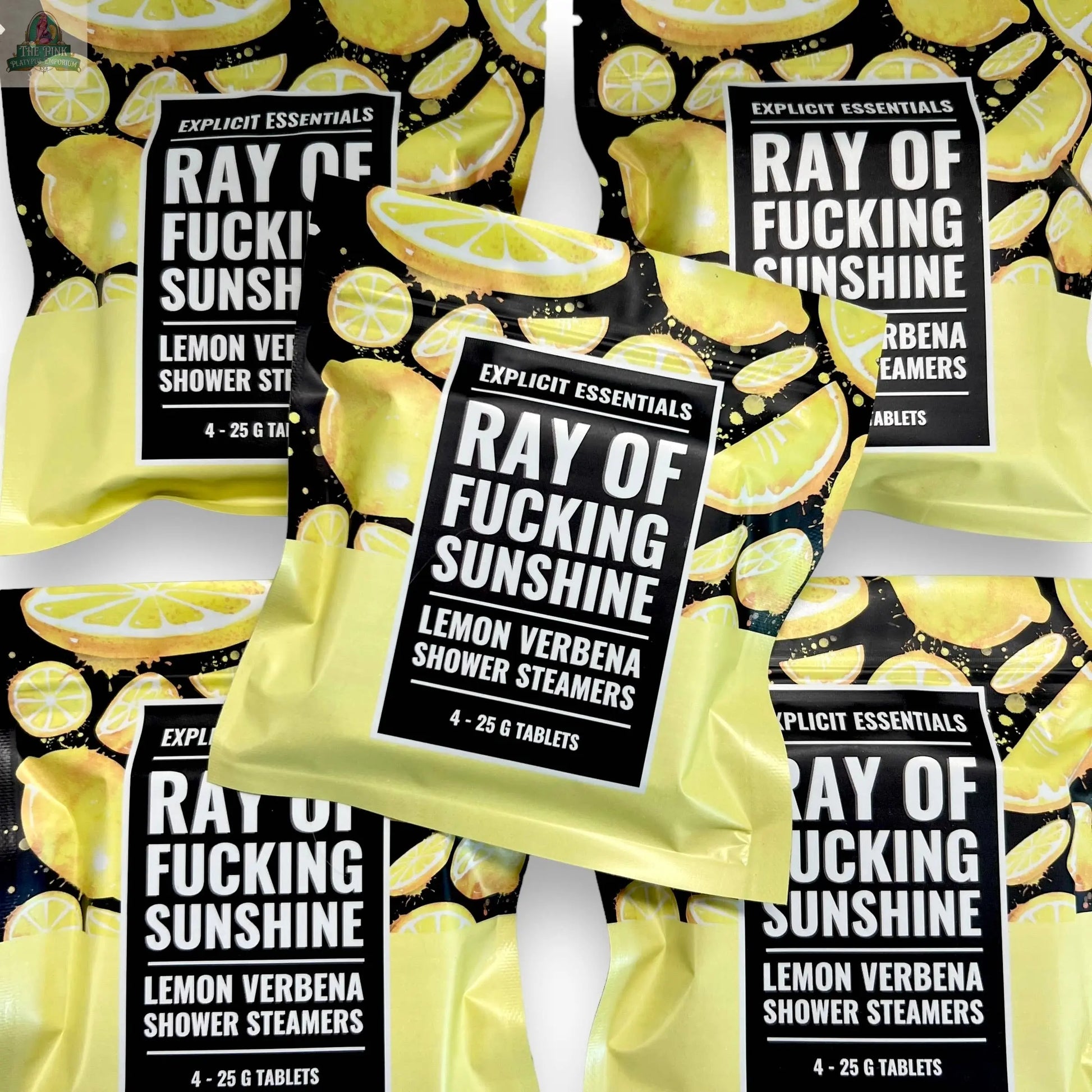 Five vibrant packages of Explicit Essentials' Ray of F&cking Sunshine Shower Steamers overlap, each showing lemons and a bold label, emphasizing their refreshing lemon verbena essential oils.