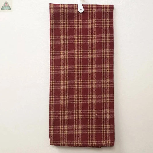 The Red Kitchen Towel With Tan Lines, made of cotton and measuring 15 x 25 inches, is neatly folded and hanging on a white wall from a white plastic hook.