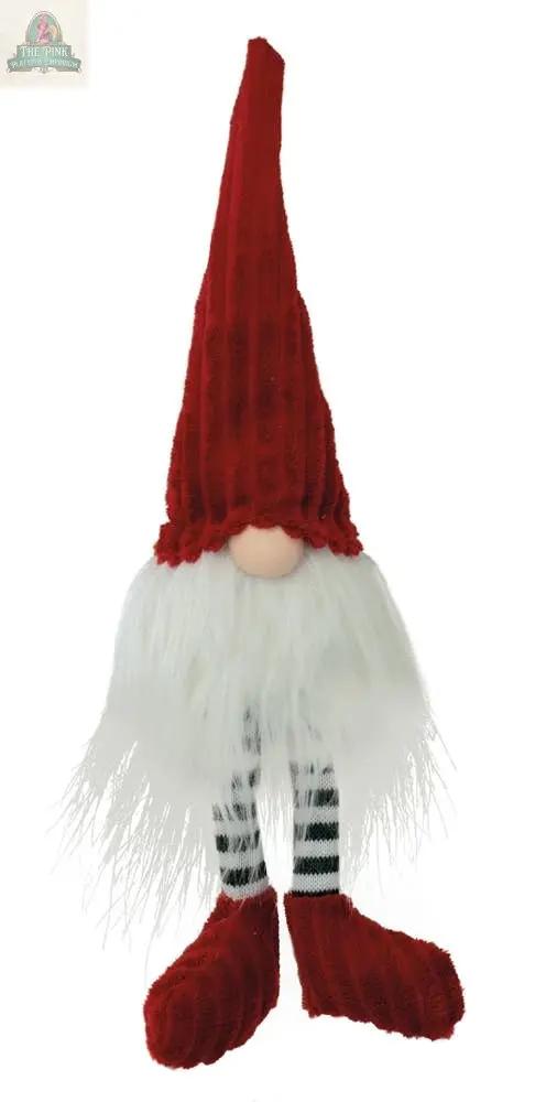 The Red & Green Elf Christmas Gnome Rudy Dangling Legs features a long red hat, white fluffy beard, round nose, and striped black and white dangling legs with large red shoes—a festive decoration for the holiday season.
