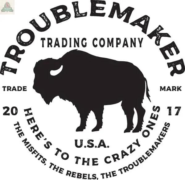 Circular logo of Troublemaker Trading Company on a large 12" round glass cutting board, charcuterie, or trivet. Bison silhouette center with the text: "Here's to the crazy ones, the misfits, the rebels, the troublemakers." Marked 2017, USA.