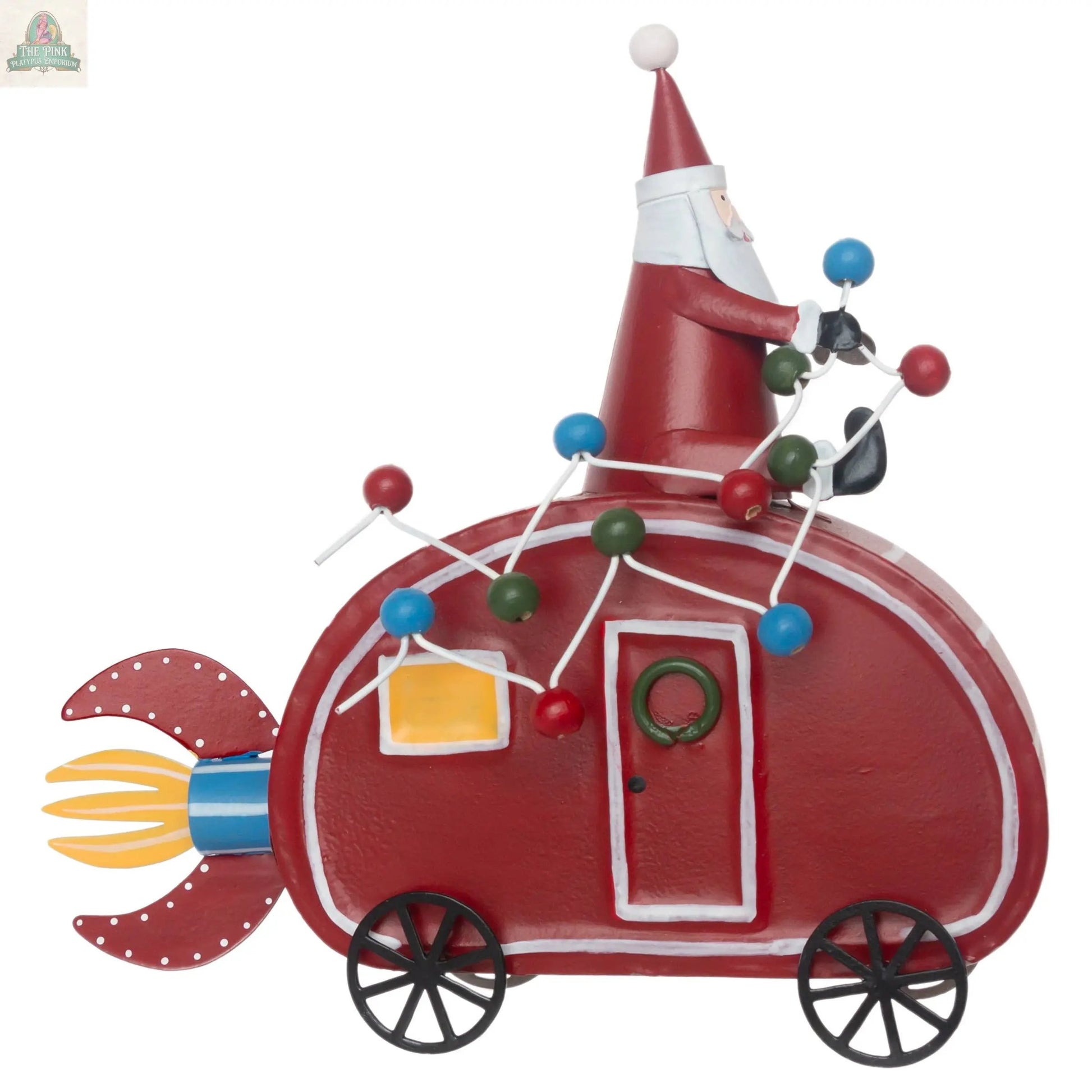 The Santa Camper Christmas Décor is a whimsical red, rocket-shaped metal vehicle with wheels, featuring Santa driving. Colorful balls and rods adorn the top, and a yellow flame blasts from the back, adding playful charm to your holiday décor.