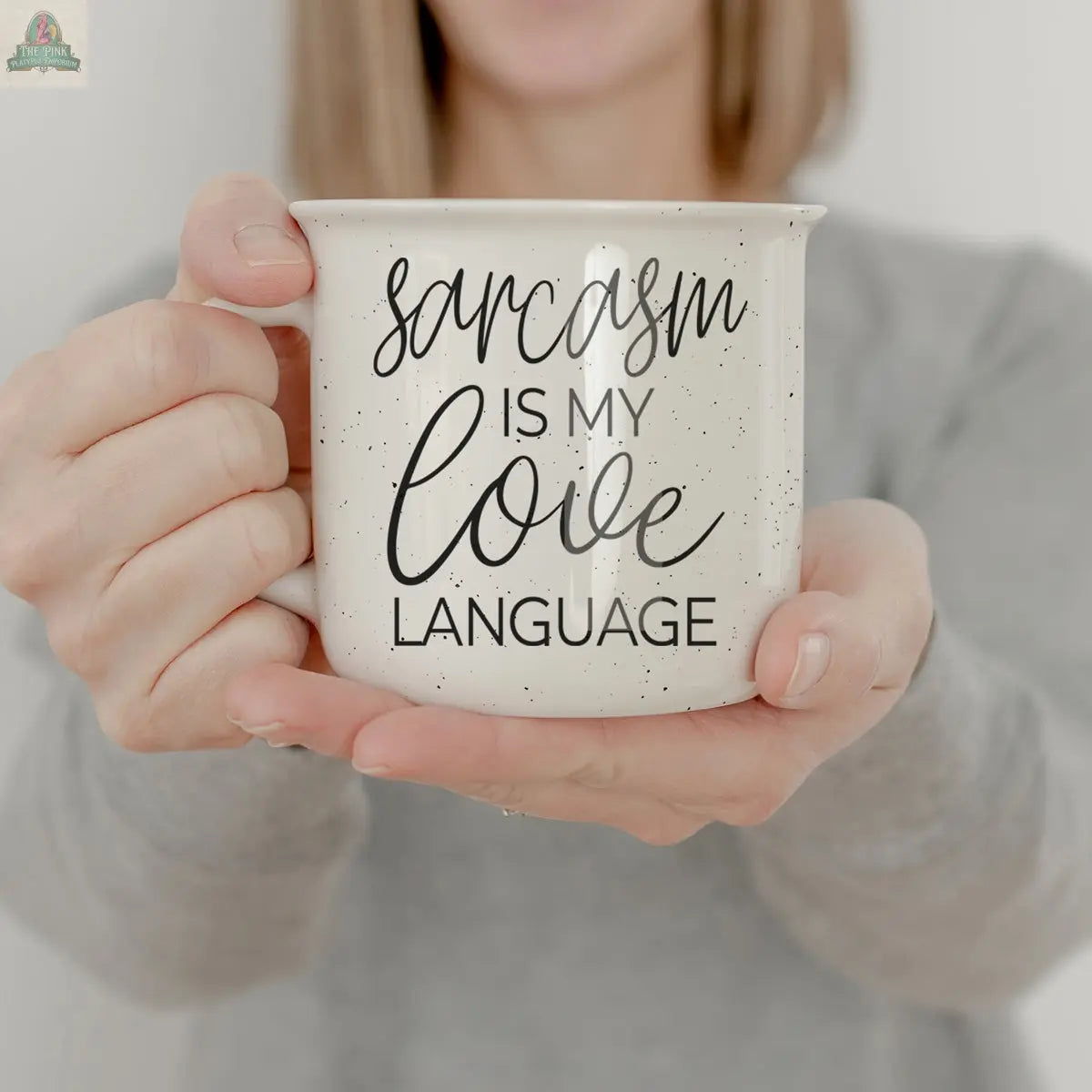 A person in a gray shirt holds the Sarcasm Love 14.5oz ceramic mug, boldly printed with “Sarcasm is my love language”—a funny gift for anyone who appreciates wit.