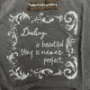 Text saying "darling, a beautiful thing is never perfect" on a dark tshirt with decorative elements