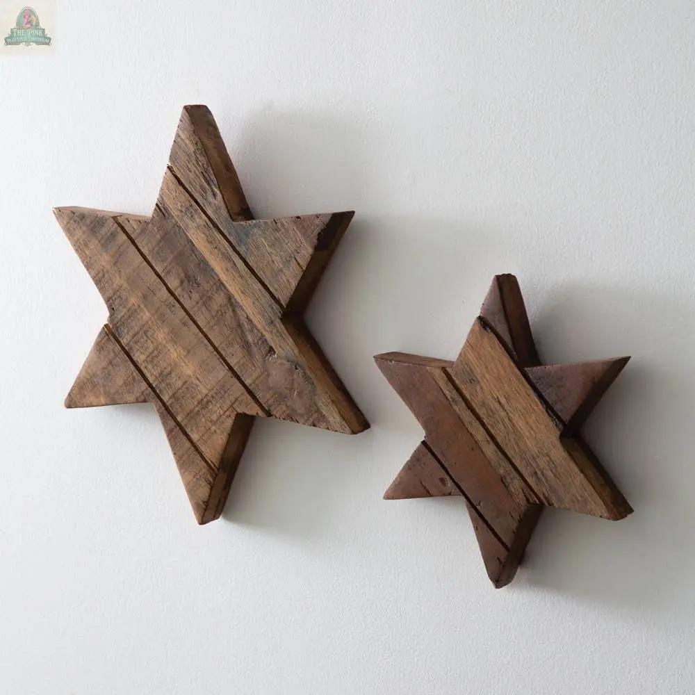 The Set of Two Salwood Christmas Stars features real wood in two sizes with visible grain and a rustic, reclaimed look, mounted on a white wall—perfect for rustic Christmas decor.