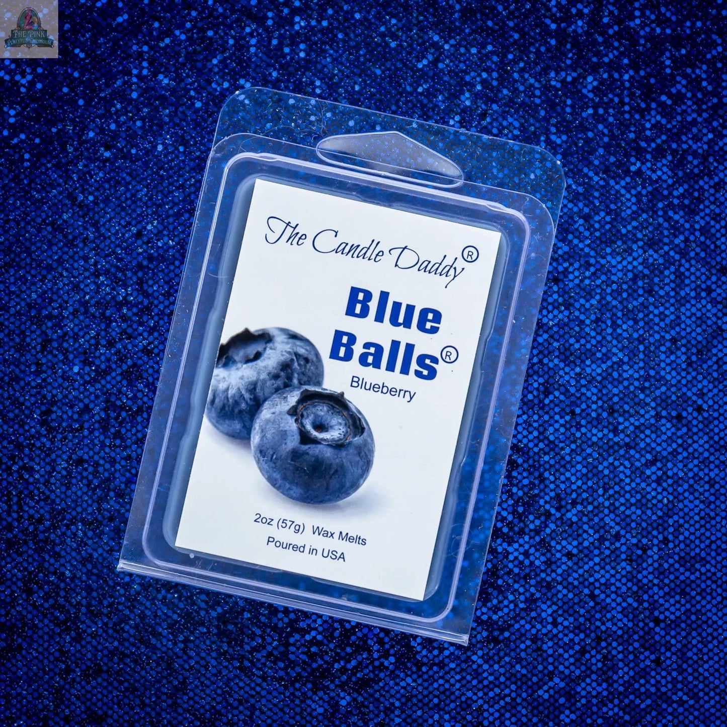 A package of TWO BLUE BALLS - RIPE BLUEBERRY SCENTED WAX MELT rests on a sparkly blue background, featuring a label with two blueberries and text describing this aromatherapy wax melt made for stress relief.