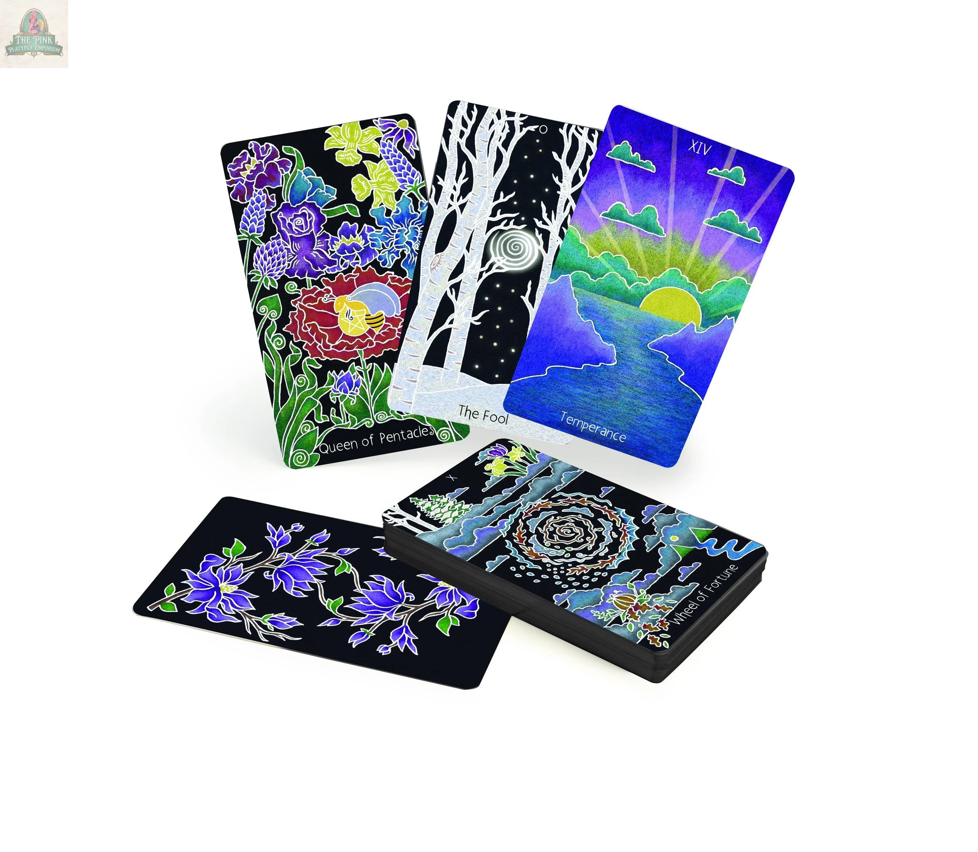 Five tarot cards from REDFeather's The Animystic Tarot Deck Box Set display vibrant nature-inspired art—flowers, trees, and a river beneath sunrise. Three cards are face up; two reveal intricate floral back designs.