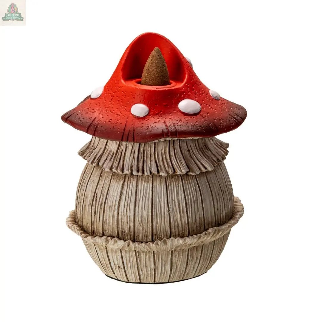 The Toadstool Mushroom Backflow Waterfall Incense Burner features a red, white-spotted cap and textured beige base, designed to hold a brown cone incense on top.