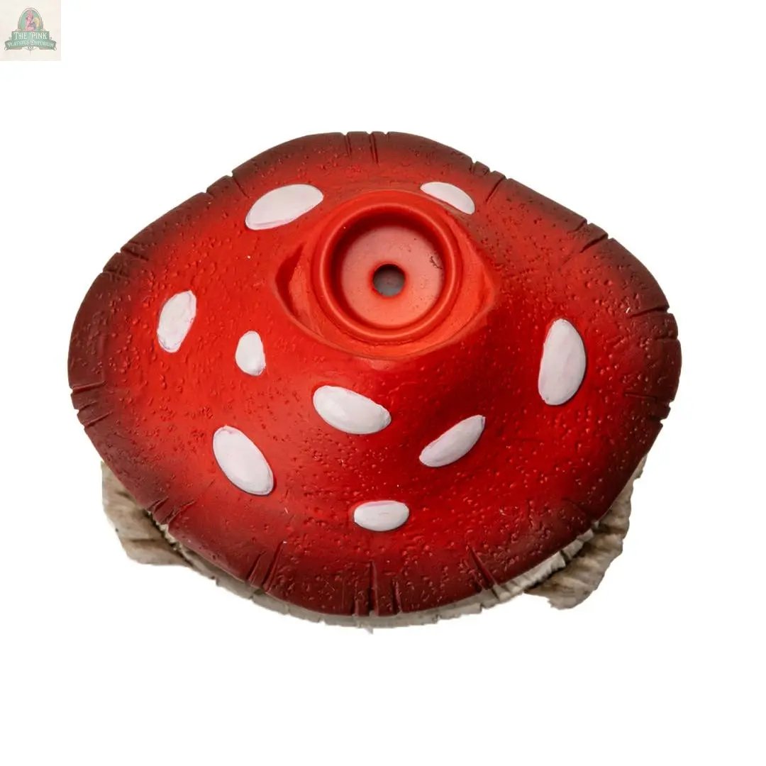 The Toadstool Mushroom Backflow Waterfall Incense Burner features a red, textured cap with white spots and a circular indentation in the center, viewed from above on a white background, with part of the stem visible at the bottom.