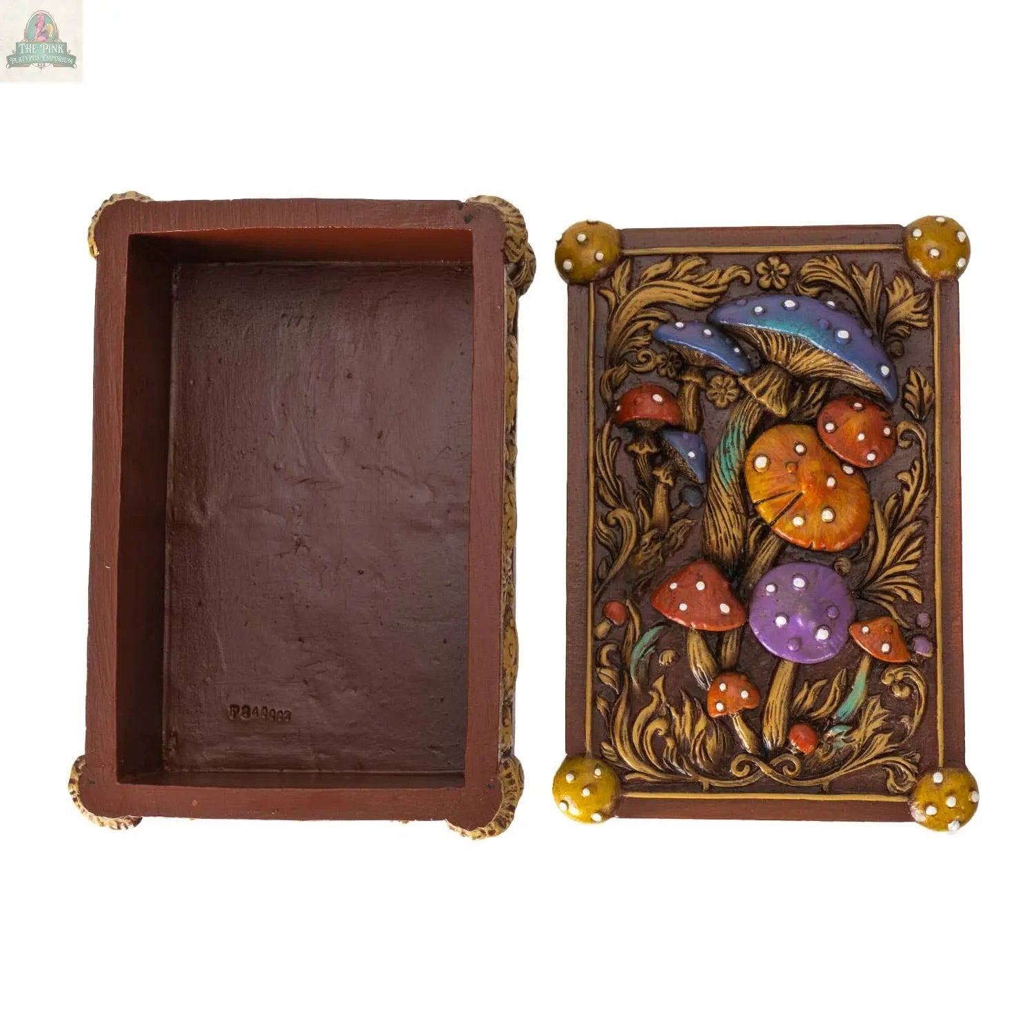 The Toadstool Mushroom Tarot Box is a rectangular brown resin box with its lid removed, revealing an empty interior. The lid features colorful mushrooms and leaves—ideal for tarot collectors.
