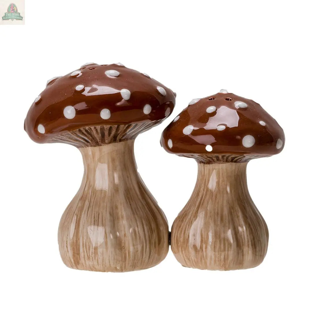 The Toadstool Mushrooms Salt and Pepper Shaker Set features two ceramic shakers with brown caps, white spots, and beige stems—an adorable, whimsical addition to your kitchen décor.