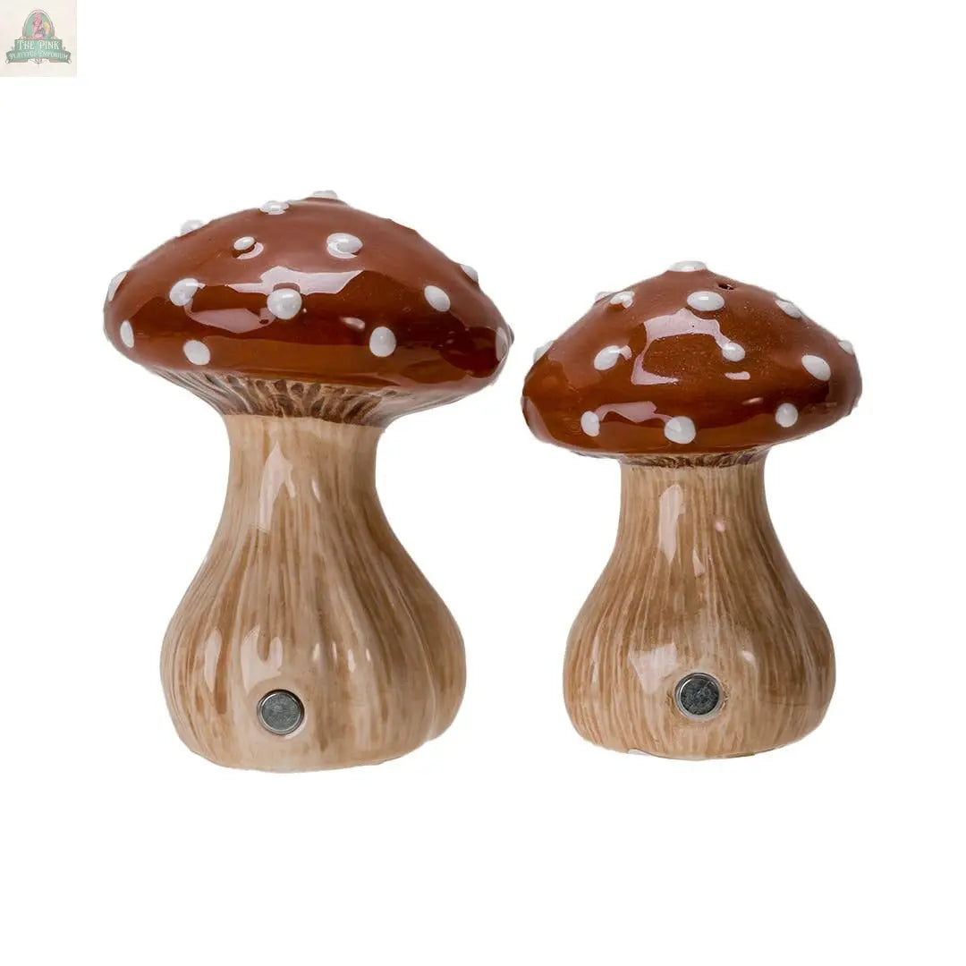 The Toadstool Mushrooms Salt and Pepper Shaker Set features two ceramic mushrooms with brown caps, white spots, beige stems, and discreet sensors at the base—perfect as unique kitchen décor or whimsical seasoning shakers.