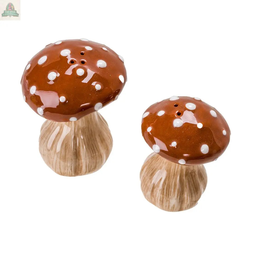 Add a whimsical touch to your kitchen décor with the Toadstool Mushrooms Salt and Pepper Shaker Set, featuring two ceramic shakers shaped like mushrooms with brown caps, white spots, and beige textured stems.