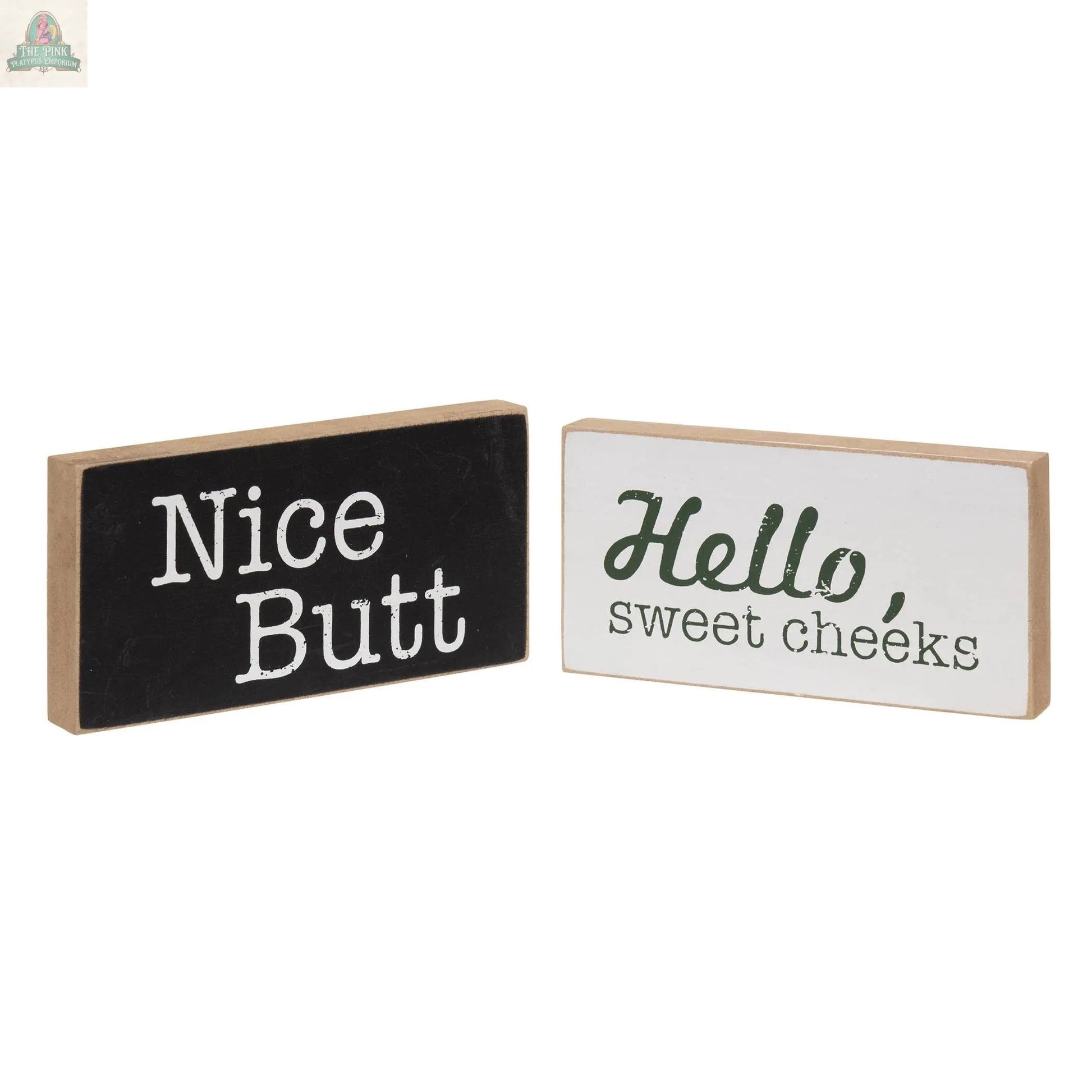The Toilet Block Sign Assorted/2 set features two rustic wood blocks with fun quotes—one black with “Nice Butt” in white, and one white with “Hello, sweet cheeks” in green and black—perfect for humorous bathroom decor.