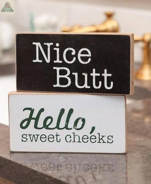 Add humor to your bathroom with the Toilet Block Sign Assorted/2 set. This rustic decor features "Nice Butt" and "Hello, sweet cheeks" designs—perfect for brightening up any bathroom counter.