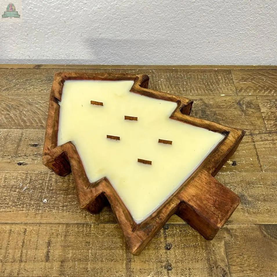 The Tree Dough Bowl, Handmade, #A features a Christmas tree shape filled with cream-colored wax and six short wooden wicks evenly spaced in the center. Displayed on a rustic wooden surface against a light wall.