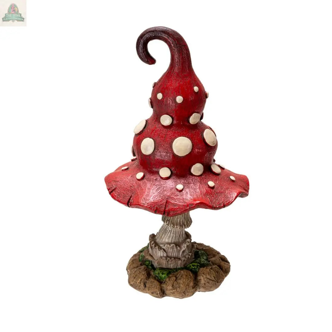 The Whimsical Toadstool Mushroom Home and Garden Decor features a red, spiral-topped mushroom with white spots and a wavy cap on a stone-like base—a delightful cottagecore accent for your home or garden.