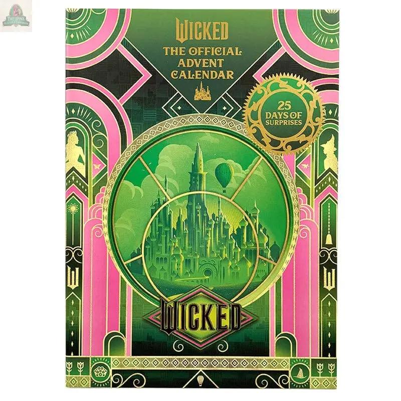 The image features the cover of Wicked: The Official Advent Calendar, showcasing green and gold art deco details, Emerald City, hot air balloons, and "25 Days of Surprises"—an ideal Oz gift or unique collectible for Wicked fans.