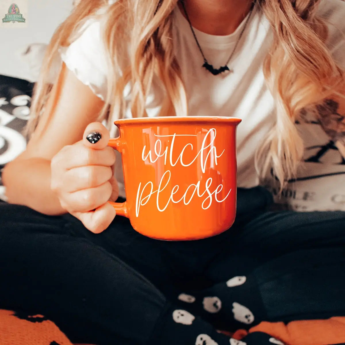 A person holding the Witch Please Mug, an orange ceramic cup that's perfect as a whimsical witch mug for your Halloween coffee rituals.