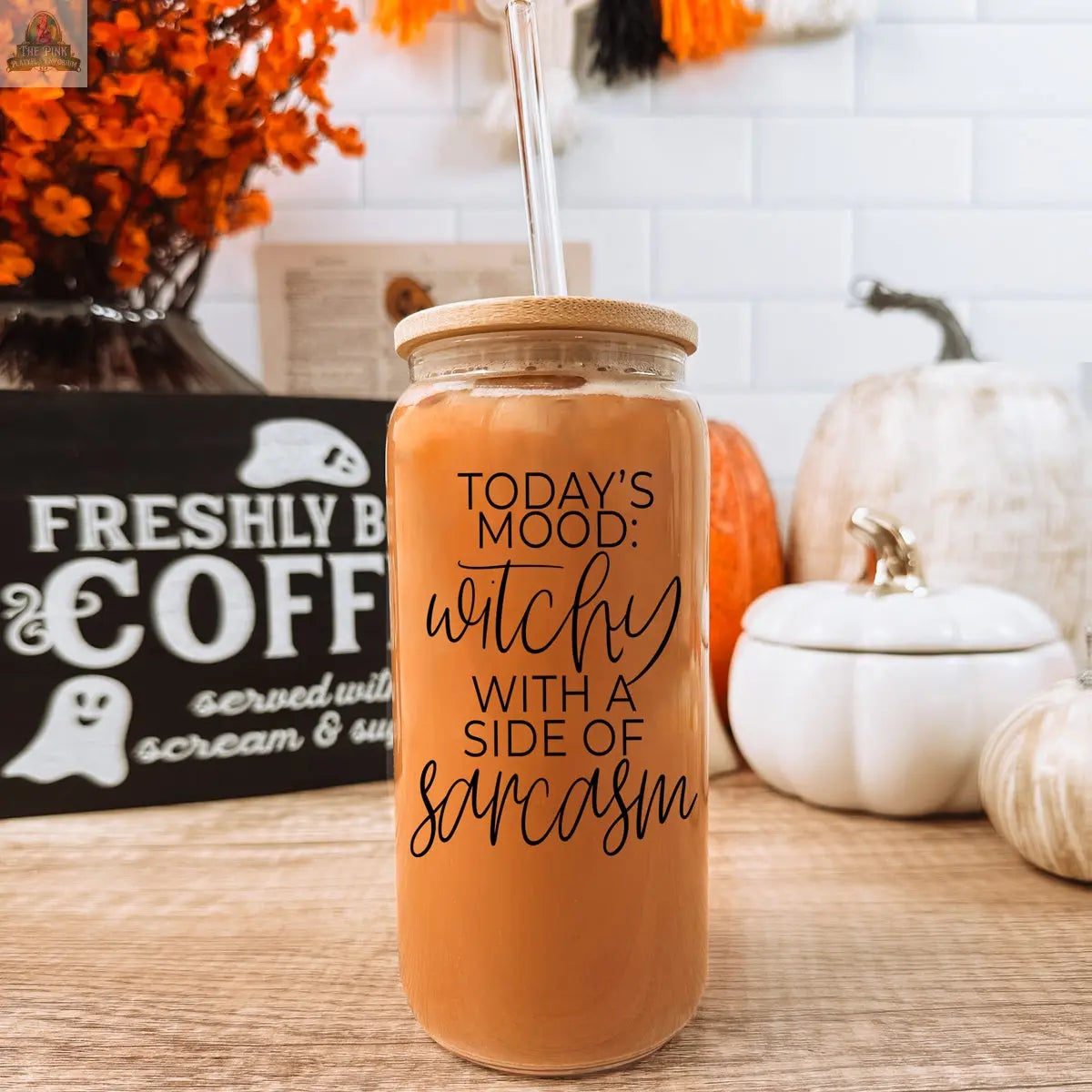 The Witchy 20oz glass tumbler with bamboo lid and straw features “Today's mood: witchy with a side of sarcasm.” Shown with pumpkins, autumn décor, and a Freshly Brewed Coffee sign—perfect as a gift for any witchy soul.