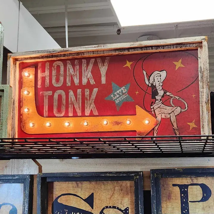 Vintage-style 'Honky Tonk' sign with a dancing woman illustration and neon lights.