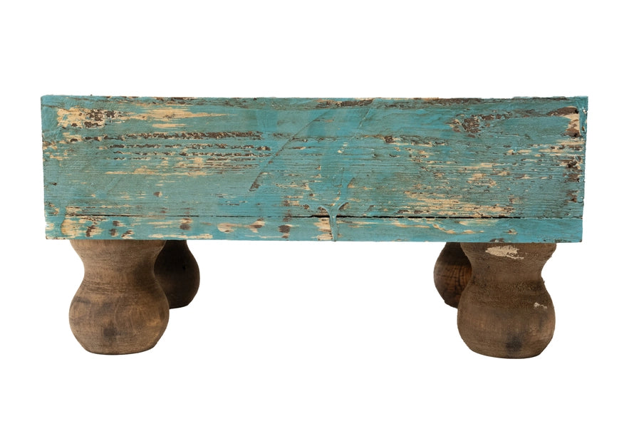 Rustic wooden planter with a distressed blue top and brown legs on a white background - quirky housewarming gift