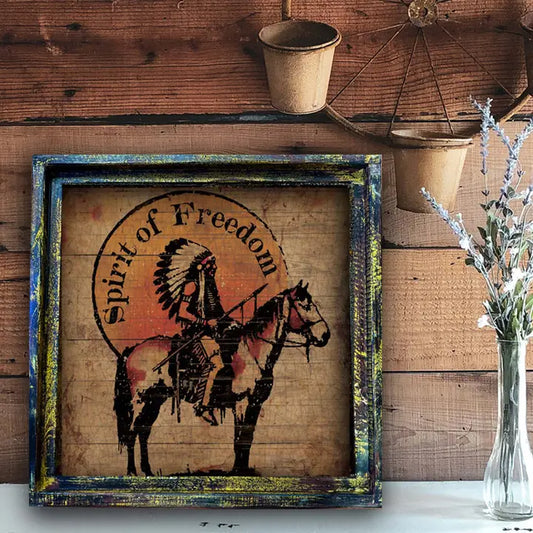 Decorative sign with 'Spirit of Freedom' and an Indian chief on a horse, framed against a wooden wall.